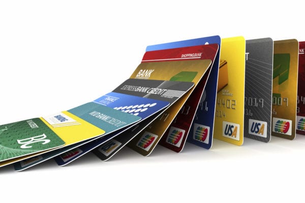 Credit cards in a row falling - credit card debt concept